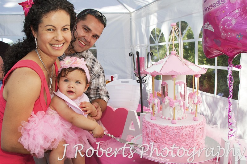 Birthday girl cutting the cake with mum and dad - Party Photography Sydney